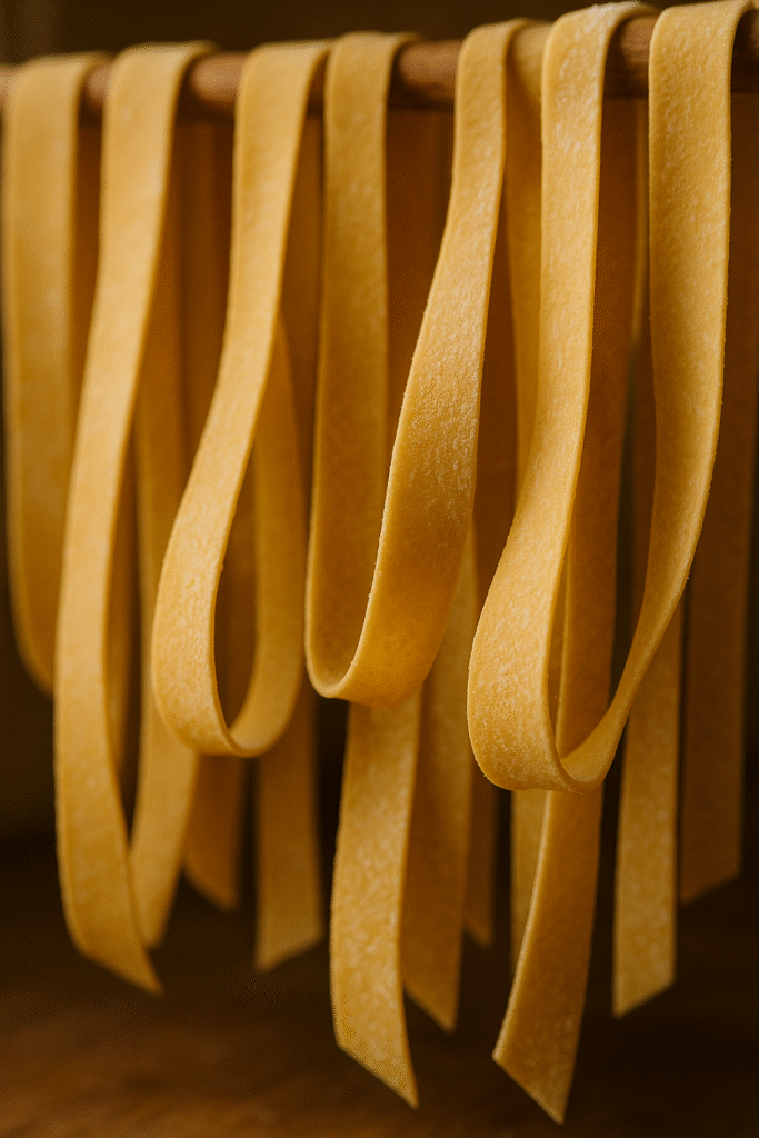 Pappardelle pasta drying in Tuscan countryside kitchen